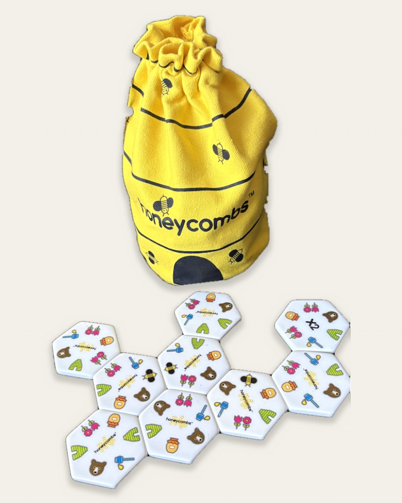 The Honeycombs matching game: a yellow beehive bag and white hexagon picture tiles