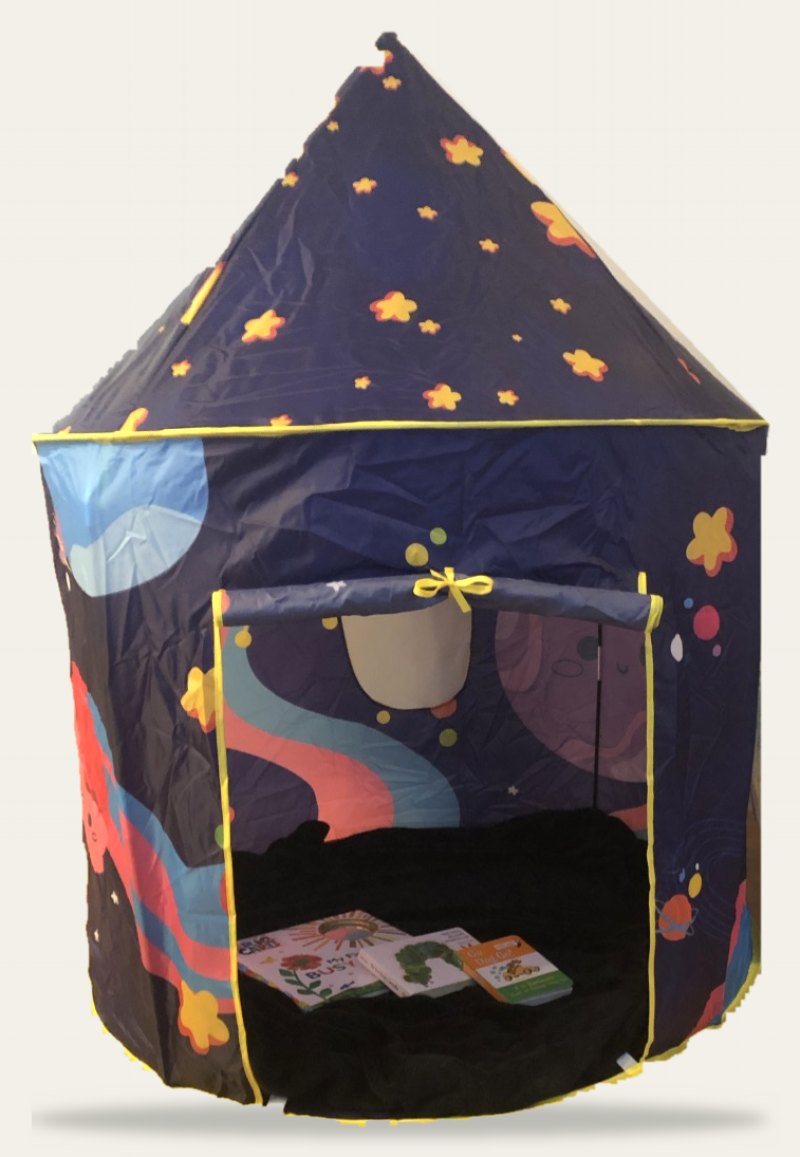 A navy blue pop-up play tent covered in stars, with picture books inside